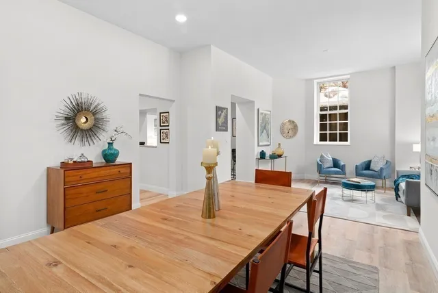 a dining room with furniture and wooden floor
