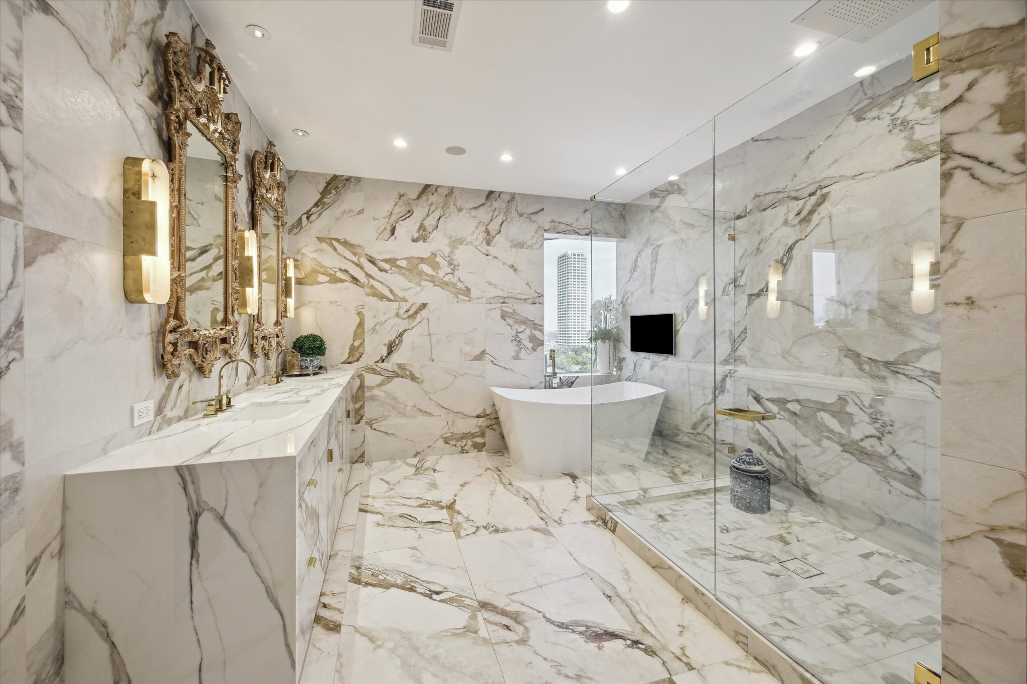 2701 Westheimer Road, Unit PHW Houston, TX 77098 - Photo 15 of 40 Primary Retreat – Boasts two walk-in closets and a spa-like en-suite with porcelain finishes, an enclosed edgeless soaking tub, and premium Buster & Punch hardware.