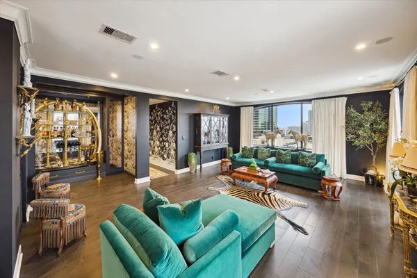 a living room with furniture and a floor to ceiling window