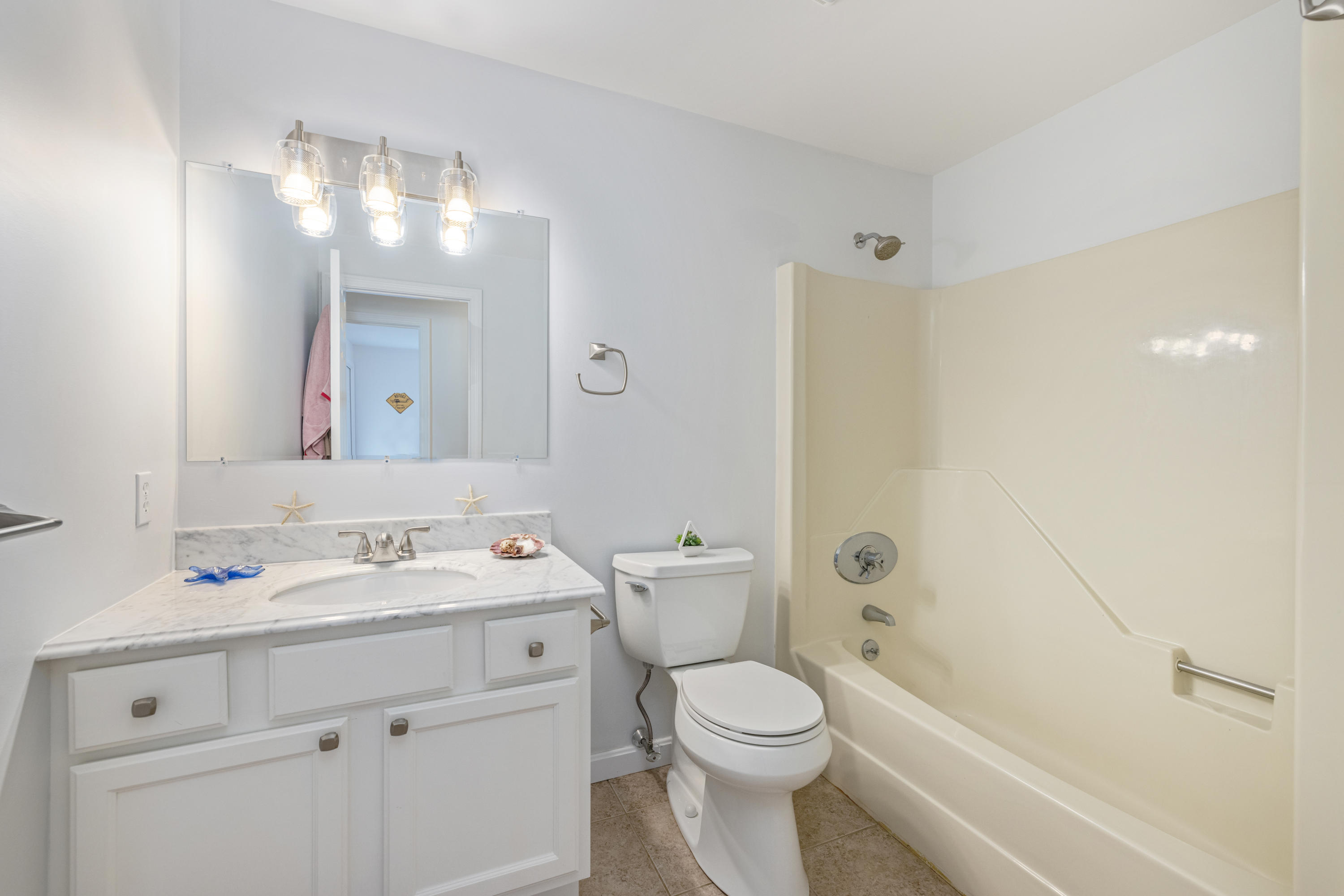 33 Cedric Road Centerville, MA 02632 - Photo 32 of 38 a bathroom with a sink a toilet and a large mirror