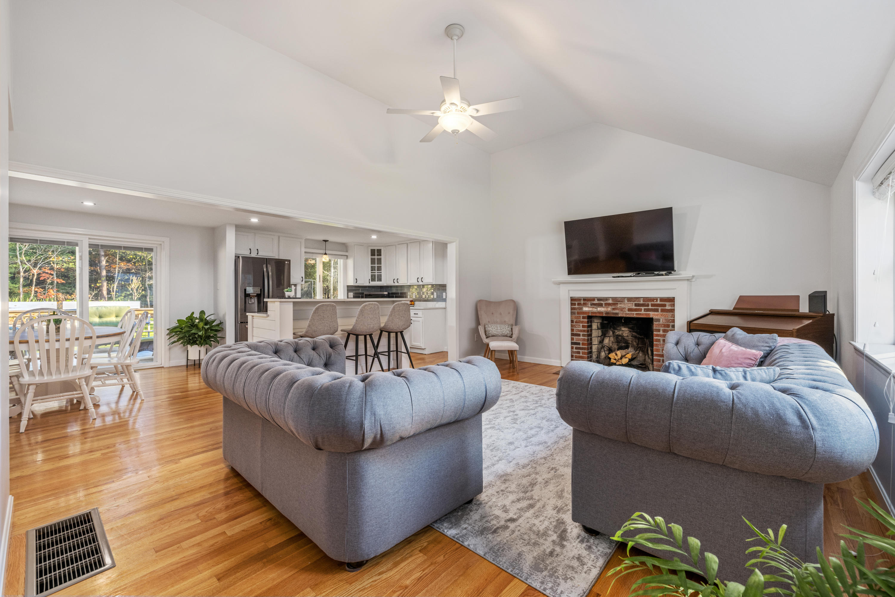 33 Cedric Road Centerville, MA 02632 - Photo 6 of 38 a living room with furniture a flat screen tv and a fireplace