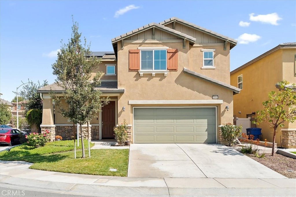 a front view of a house with a yard and garage