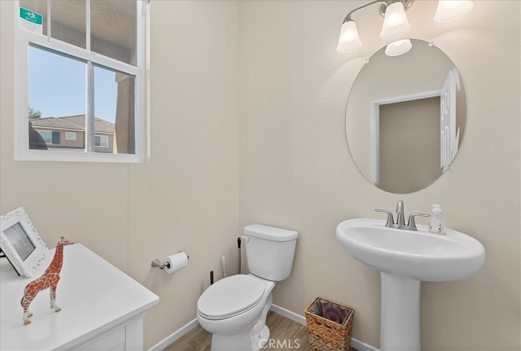 10969 Elkwood Circle Riverside, CA 92503 - Photo 12 of 42 a bathroom with a toilet sink and mirror