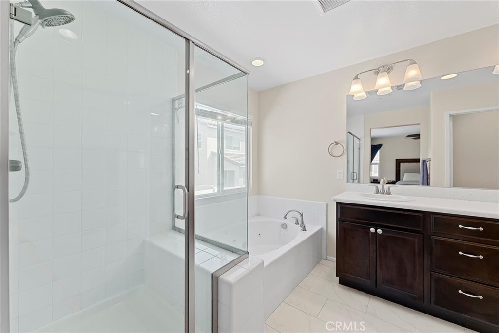 10969 Elkwood Circle Riverside, CA 92503 - Photo 18 of 42 a spacious bathroom with a shower sink and mirror