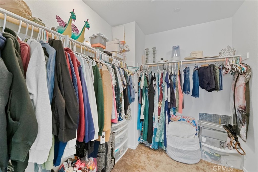 10969 Elkwood Circle Riverside, CA 92503 - Photo 20 of 42 a view of walk in closet with clothes