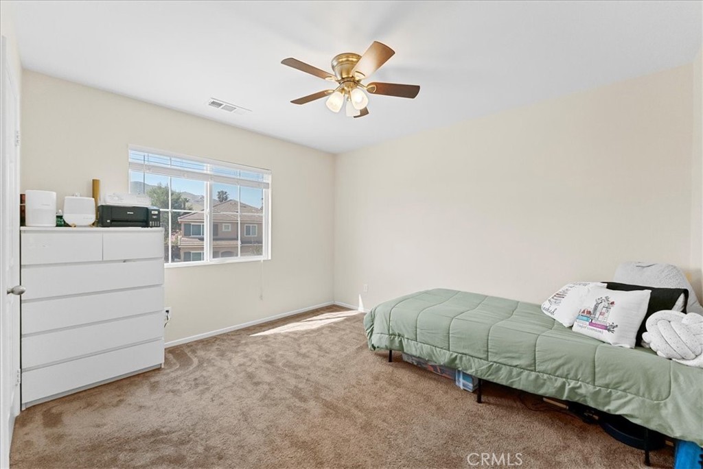 10969 Elkwood Circle Riverside, CA 92503 - Photo 21 of 42 a living room with couches and ceiling fan with dresser