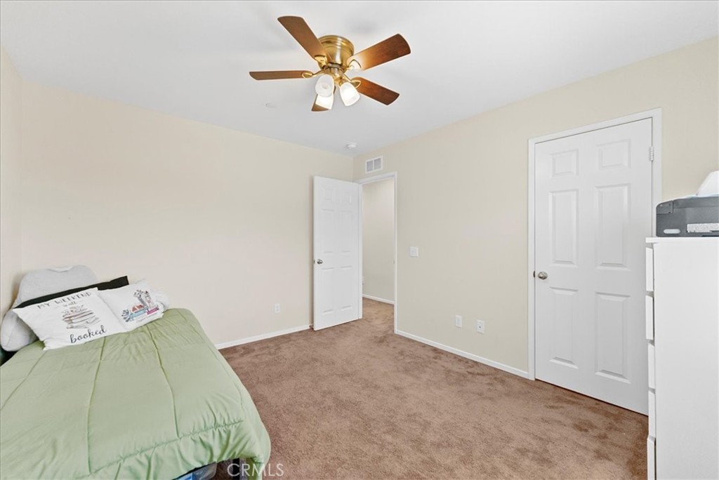 10969 Elkwood Circle Riverside, CA 92503 - Photo 22 of 42 a bedroom with a bed and a ceiling fan