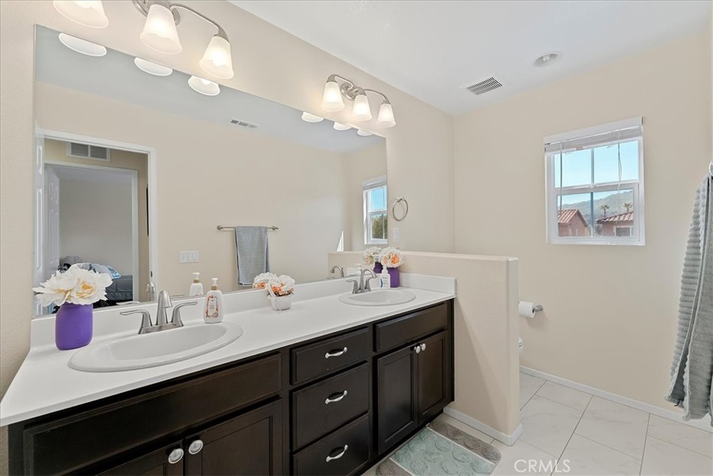 10969 Elkwood Circle Riverside, CA 92503 - Photo 23 of 42 a bathroom with a sink double vanity and a mirror