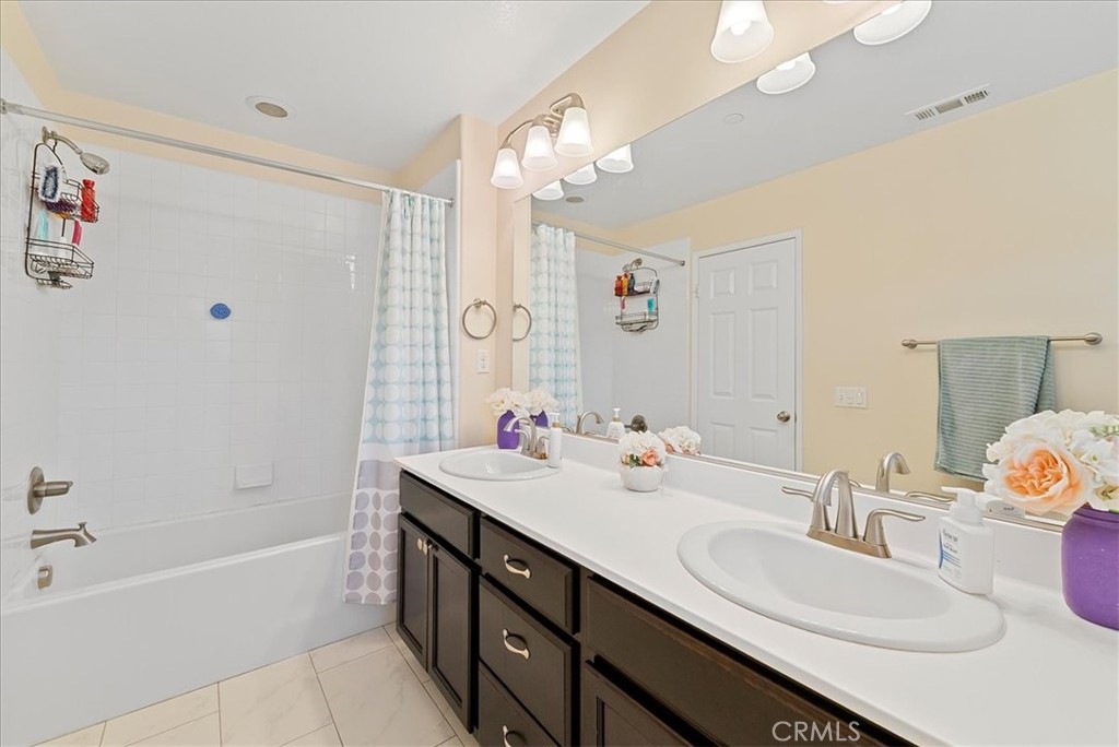 10969 Elkwood Circle Riverside, CA 92503 - Photo 24 of 42 a bathroom with a double vanity sink and a mirror