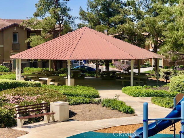 10969 Elkwood Circle Riverside, CA 92503 - Photo 38 of 42 a view of a patio with table and chairs under an umbrella
