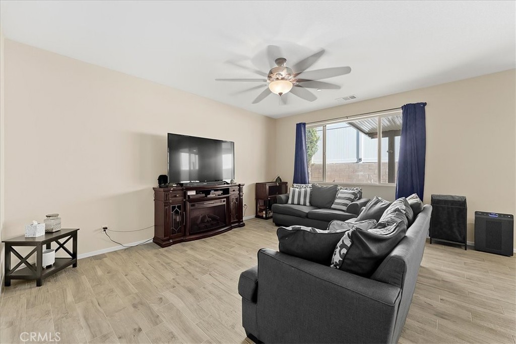 10969 Elkwood Circle Riverside, CA 92503 - Photo 4 of 42 a living room with furniture and a flat screen tv