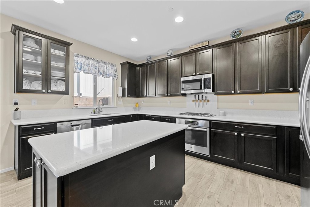 10969 Elkwood Circle Riverside, CA 92503 - Photo 8 of 42 a kitchen with a sink a stove and cabinets