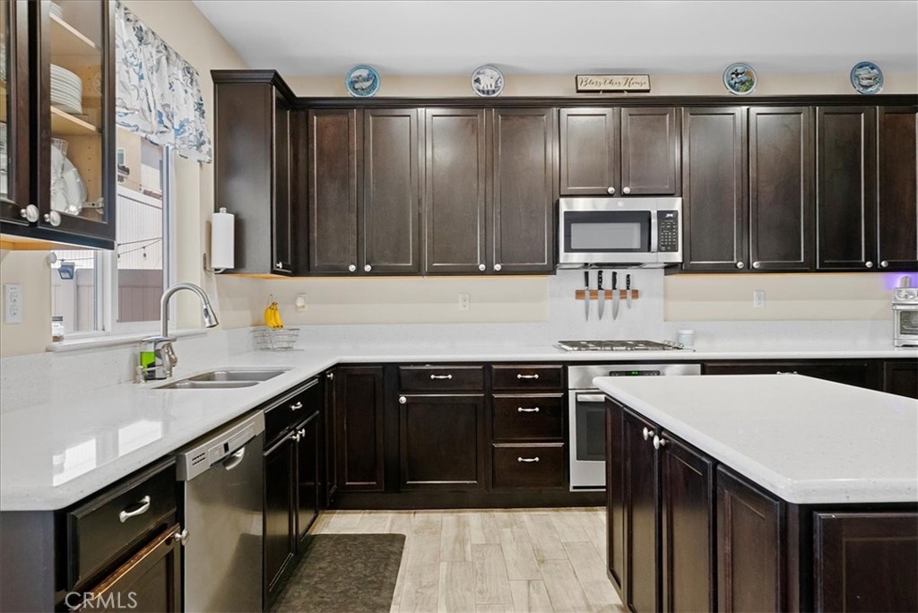 10969 Elkwood Circle Riverside, CA 92503 - Photo 10 of 42 a kitchen with a stove a sink and a microwave