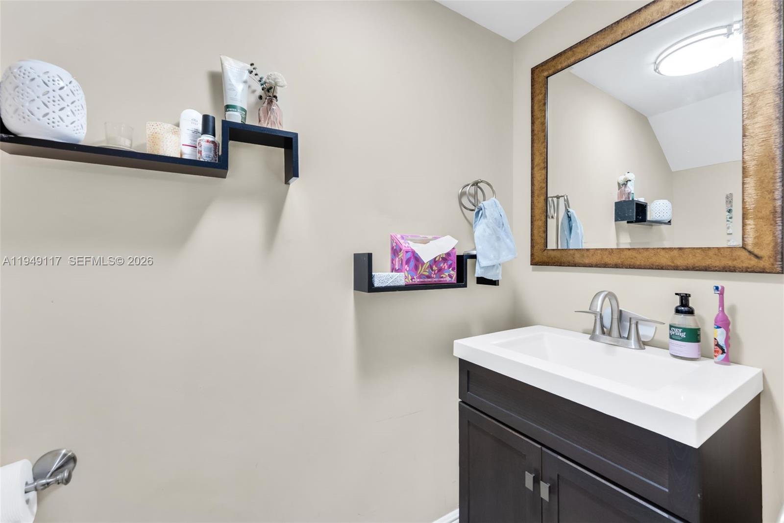 7858 Southwest 102nd Lane Miami, FL 33156 - Photo 14 of 22 a bathroom with a sink vanity and a mirror