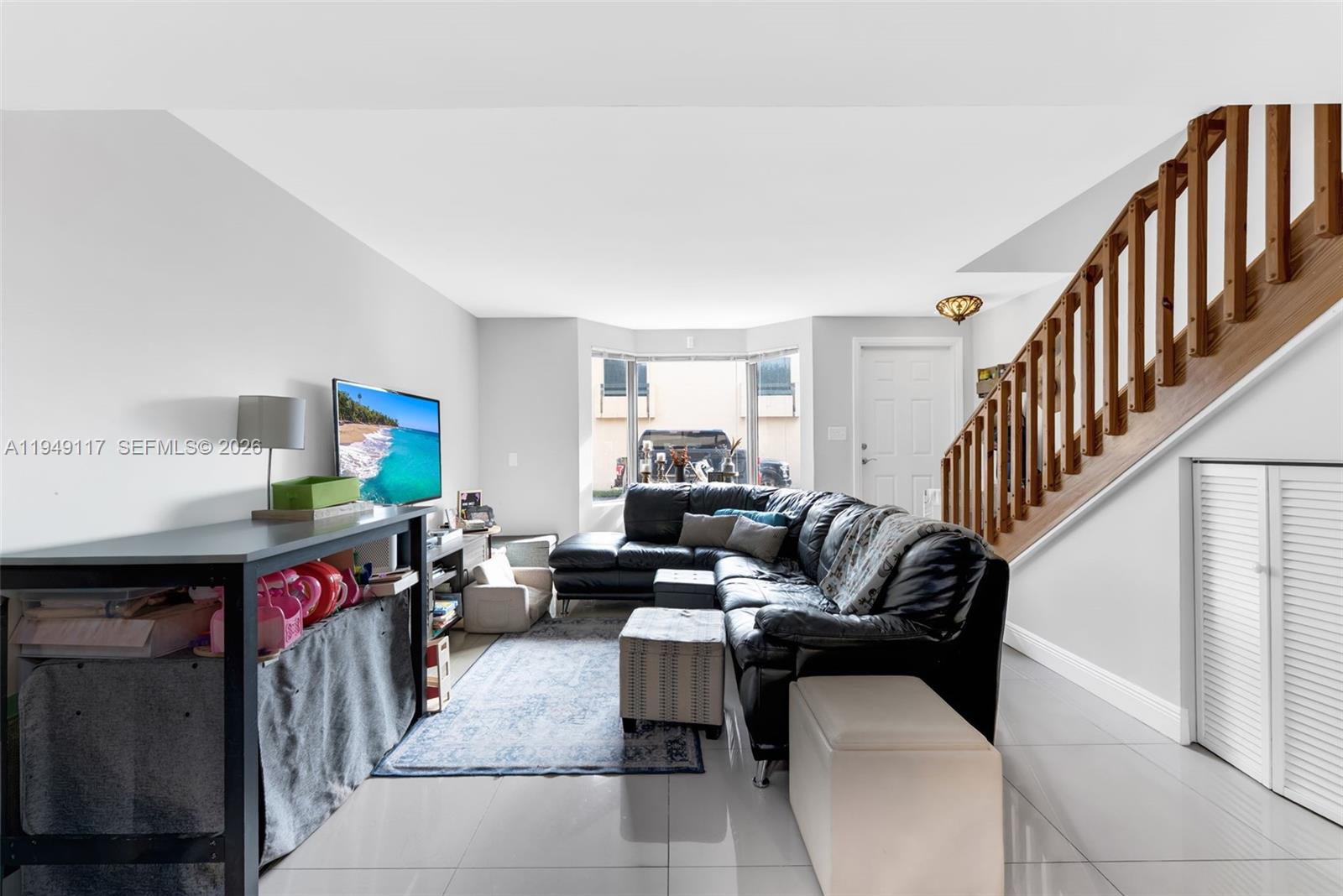 7858 Southwest 102nd Lane Miami, FL 33156 - Photo 7 of 22 a living room with furniture and a flat screen tv