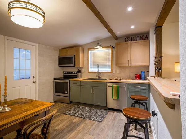 a kitchen with a stove a sink and a refrigerator