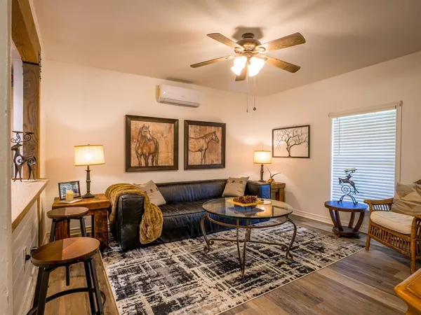a living room with furniture a rug and a window