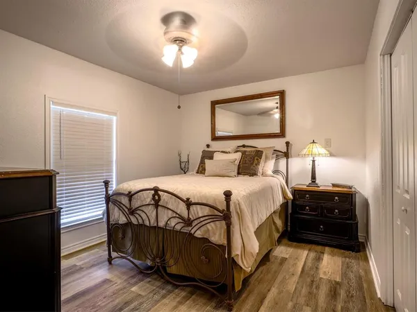 a bedroom with a bed and wooden floor