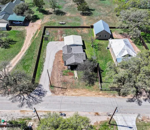 an aerial view of house with yard