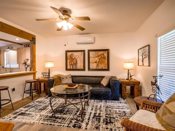 a living room with furniture and a chandelier