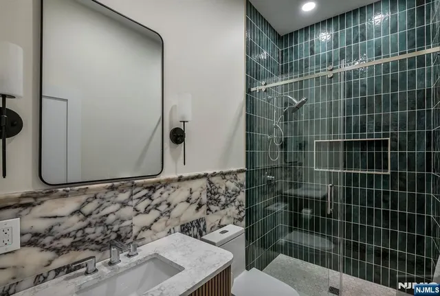 a bathroom with a sink toilet and shower
