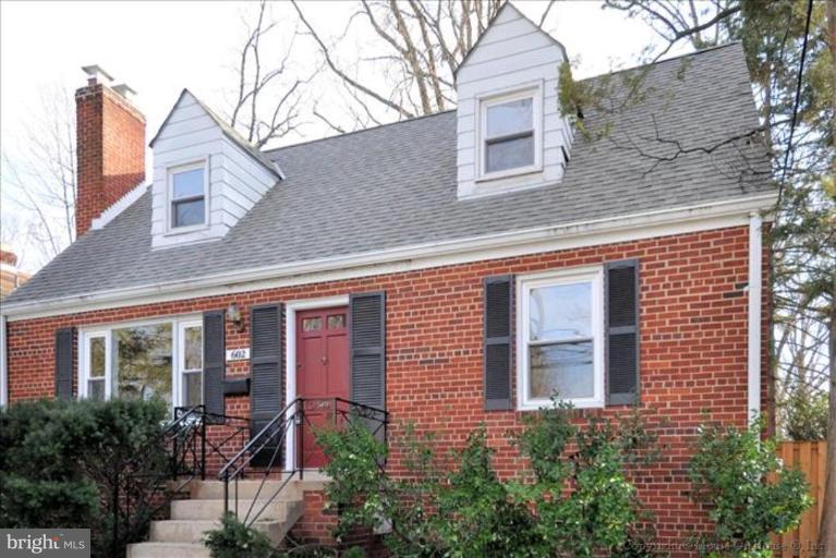 602 Lanark Way Silver Spring, MD 20901 - Photo 2 of 24 front view of a brick house many windows and potted plants
