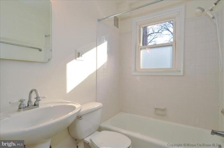602 Lanark Way Silver Spring, MD 20901 - Photo 11 of 24 a bath room with a toilet a sink and a bath tub