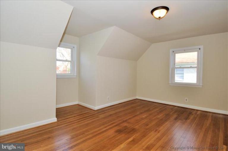 602 Lanark Way Silver Spring, MD 20901 - Photo 12 of 24 an empty room with wooden floor and windows