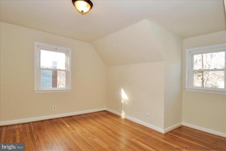 602 Lanark Way Silver Spring, MD 20901 - Photo 13 of 24 an empty room with wooden floor and windows