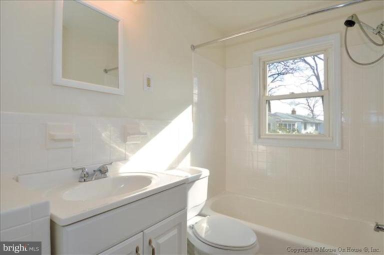 602 Lanark Way Silver Spring, MD 20901 - Photo 14 of 24 a bathroom with a sink toilet a mirror and shower