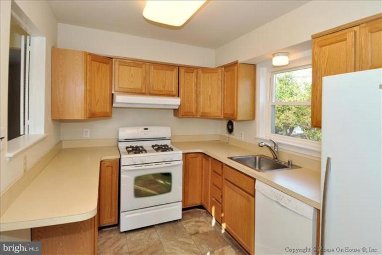 602 Lanark Way Silver Spring, MD 20901 - Photo 7 of 24 a kitchen with a stove sink and cabinets