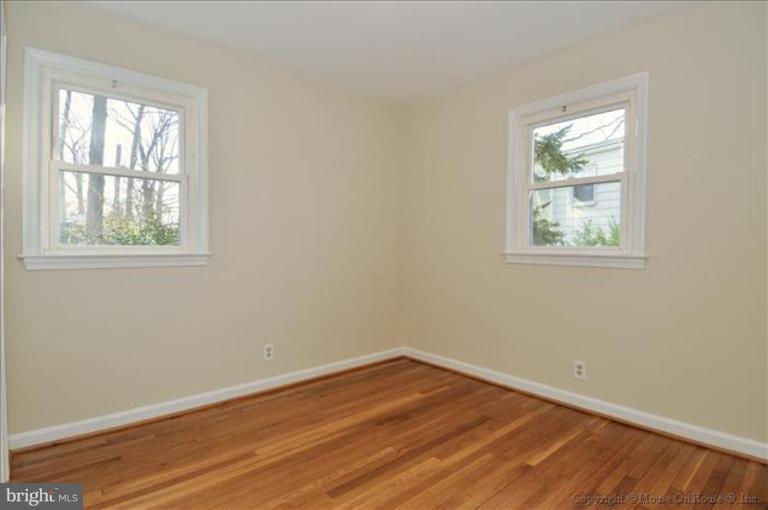 602 Lanark Way Silver Spring, MD 20901 - Photo 9 of 24 an empty room with wooden floor and windows