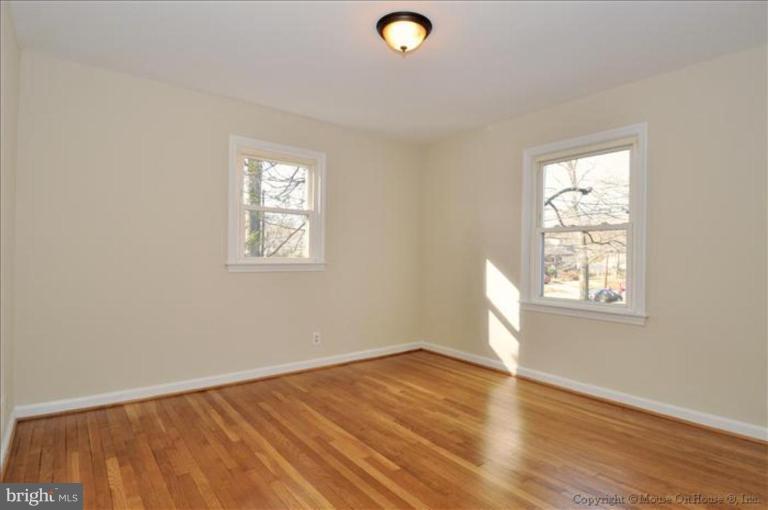 602 Lanark Way Silver Spring, MD 20901 - Photo 10 of 24 an empty room with wooden floor and windows
