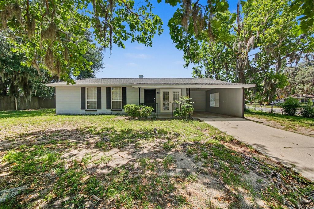 1109 Inland Street Leesburg, FL 34748 - Photo 1 of 15 a front view of house with yard and green space