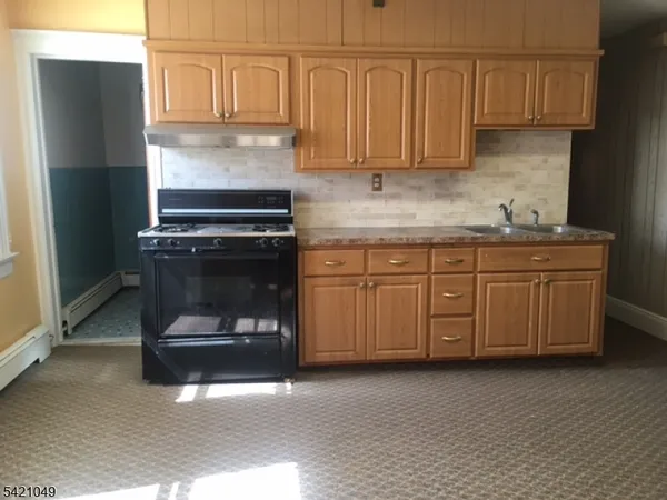 a kitchen with a cabinets and white appliances