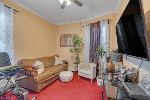 a living room with furniture a rug and a chandelier