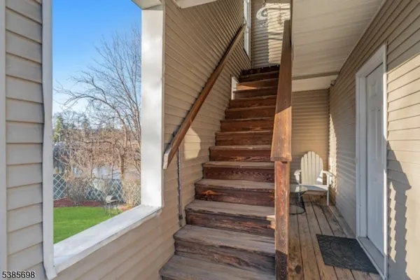 a view of entryway with wooden floor and stairs