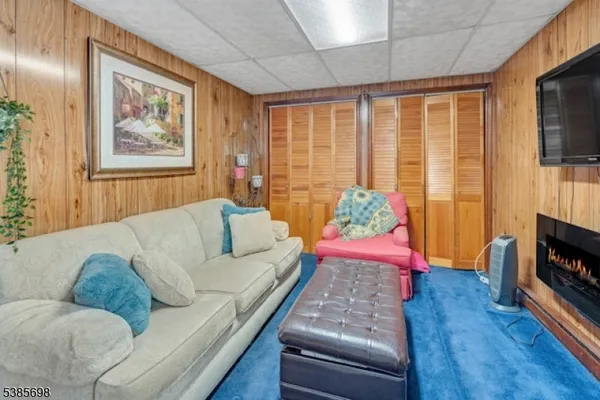 a living room with furniture fireplace and flat screen tv