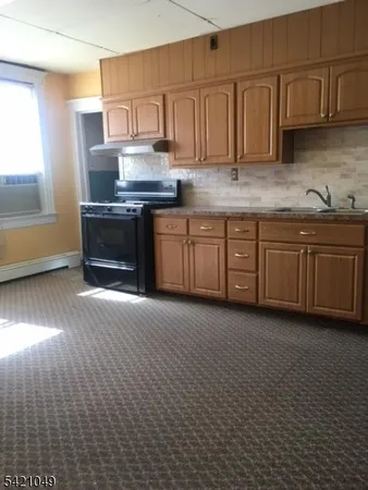 a kitchen with stainless steel appliances granite countertop a stove a sink and a granite counter tops