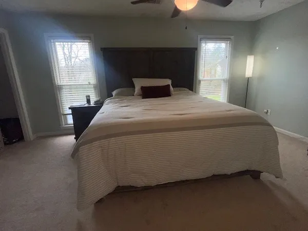 a bedroom with a bed and window