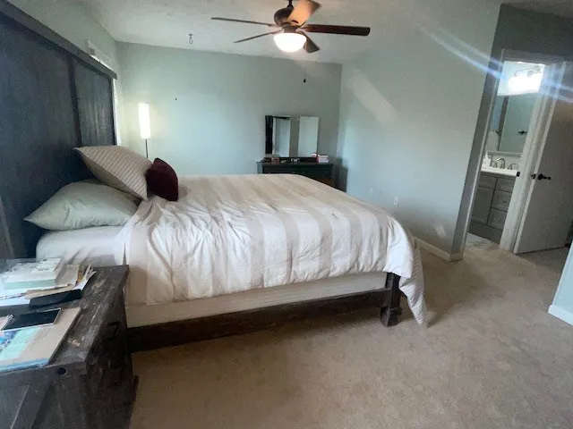 a bedroom with a bed and a chandelier