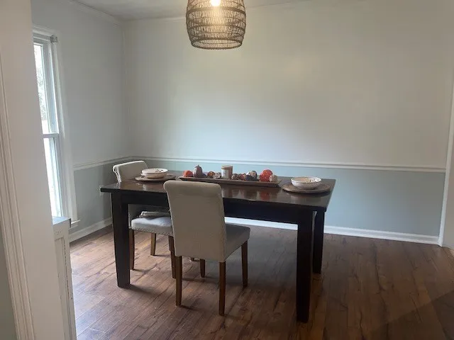 a view of a dining room with furniture and wooden floor