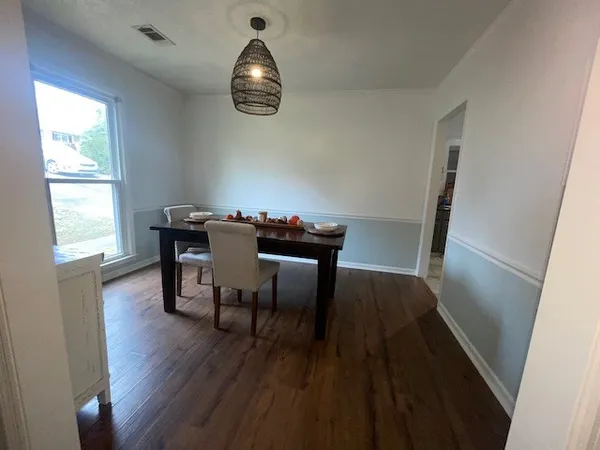 a view of a dining room with furniture window and wooden floor