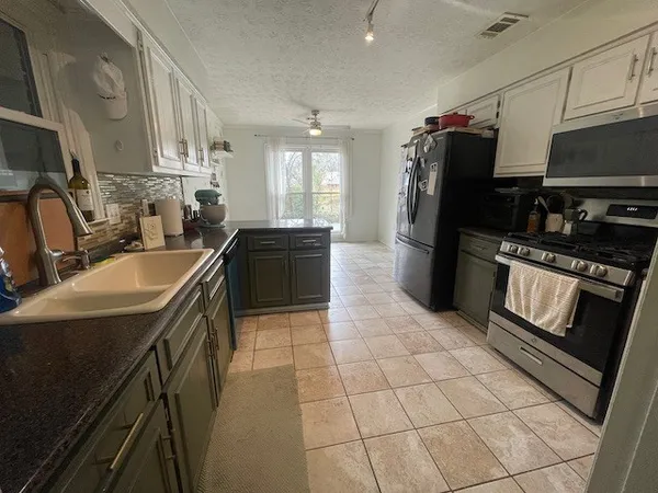 a kitchen with a sink appliances and cabinets