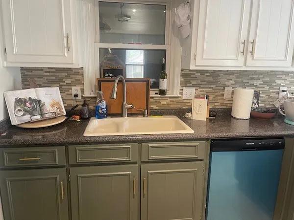 a kitchen with a sink and cabinets
