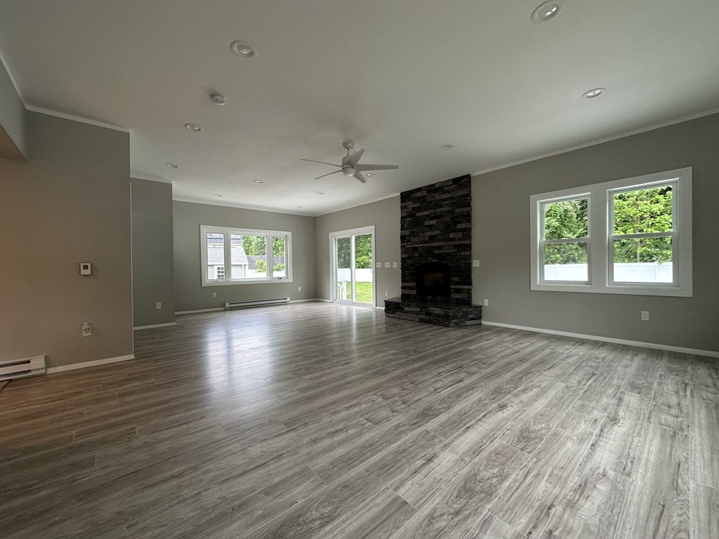 26 Worthington Road Huntington, MA 01050 - Photo 12 of 25 an empty room with wooden floor wooden floor and windows