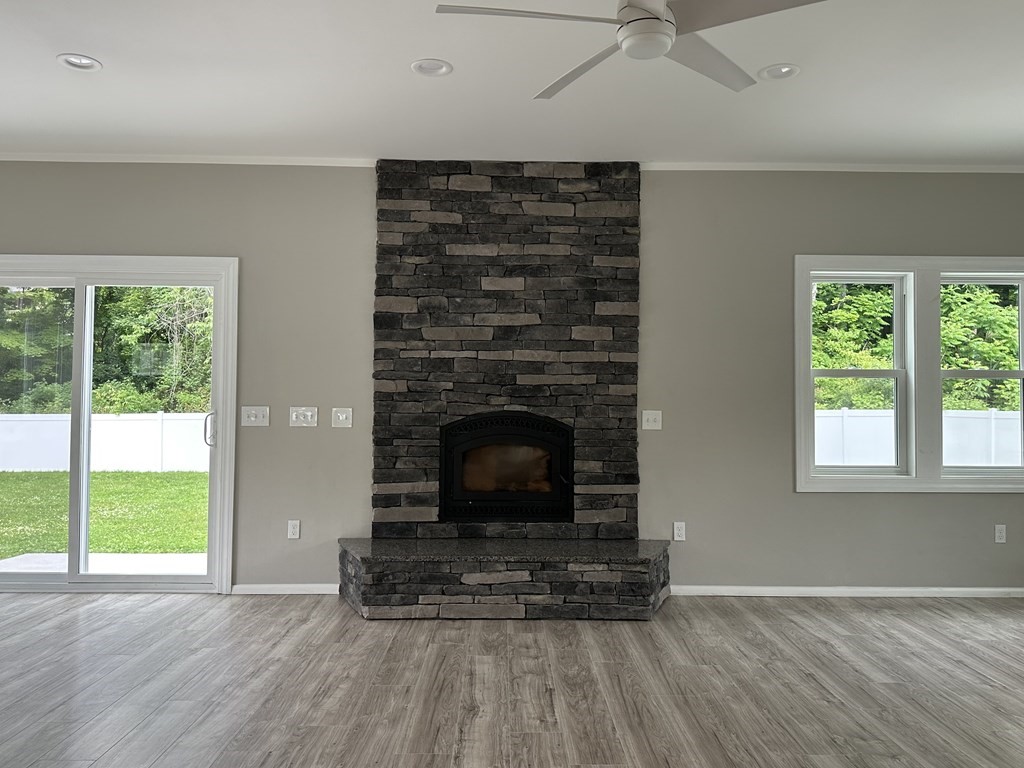 26 Worthington Road Huntington, MA 01050 - Photo 13 of 25 an empty room with wooden floor a fireplace and windows