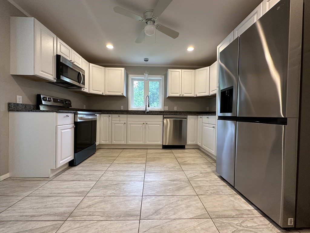 26 Worthington Road Huntington, MA 01050 - Photo 14 of 25 a kitchen with stainless steel appliances granite countertop a refrigerator and a stove top oven
