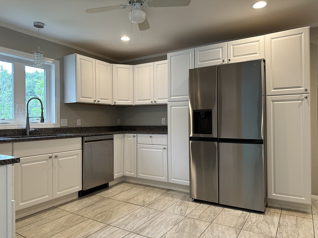 26 Worthington Road Huntington, MA 01050 - Photo 15 of 25 a kitchen with stainless steel appliances granite countertop a refrigerator a sink a stove a microwave and cabinets
