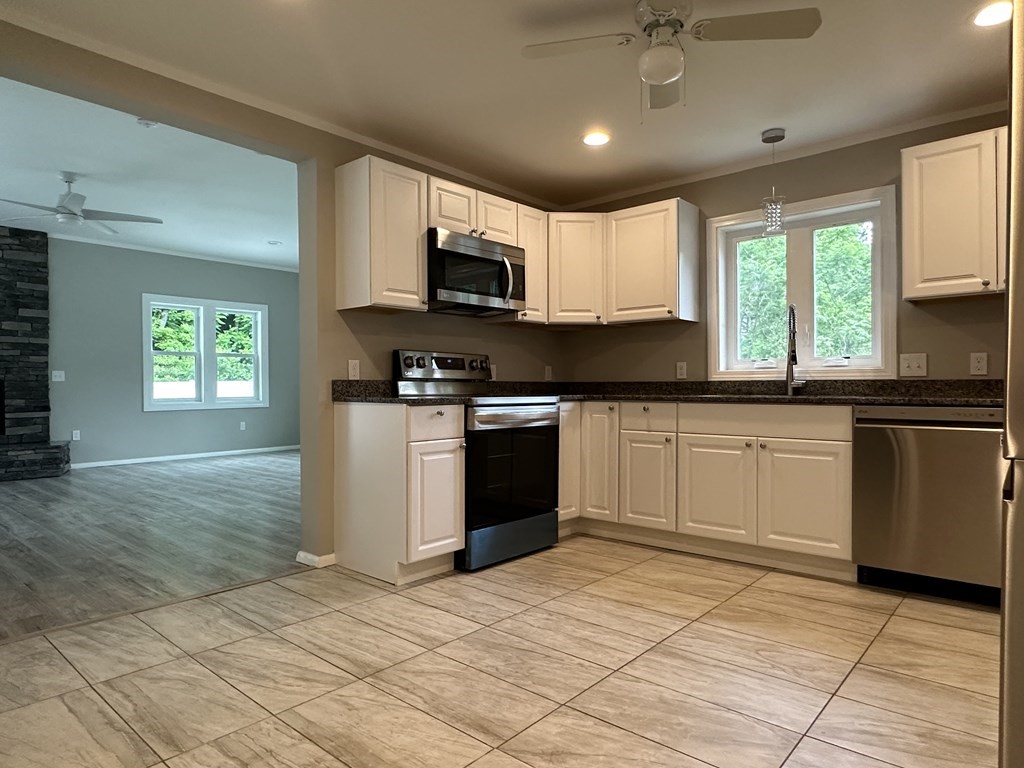 26 Worthington Road Huntington, MA 01050 - Photo 16 of 25 a kitchen with stainless steel appliances granite countertop a stove sink and microwave